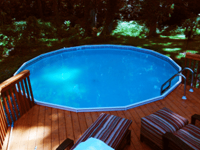 wooden above ground pool with ladder and deck